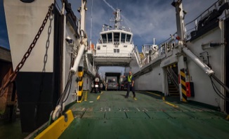 Boarding a small CalMac ferry  - part of the West Coast Cycle Trail